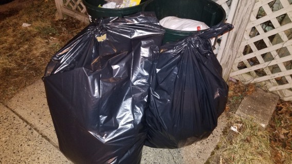 trash removed from neighboring house due to damage
